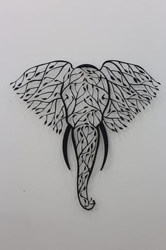 an elephant with intricate designs on it's head is shown in black and white