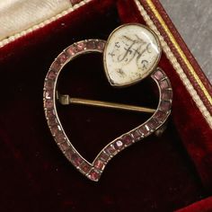 This a lovely 15ct gold pendant from the mid-Georgian era. The pendant is in a classic witches heart style but features a rare addition, a cartouche displaying the letters FH crafted in wonderful hair work.  The witches heart brooch was given to a loved one to help keep away the evil spirits, the brooch was also pinned to the swaddling blankets of babies for the same reason.  Condition: Used (Very Good) Weight: 2.1 grams Dimensions: 25mm x 20mm x 3mm (not including pin) Tested As: 15ct Gold Peri Victorian Brooches With Locket Pendant, Victorian Locket Pendant Brooches, Antique Medallion Brooch For Wedding, Antique Baroque Brooches With 17 Jewels, Yellow Gold Baroque Brooches As Gift, Baroque Yellow Gold Brooch For Gift, Yellow Gold Baroque Brooch For Gift, Victorian Baroque Brooches As Gifts, Vintage Yellow Gold Brooches With Rose Cut Diamonds