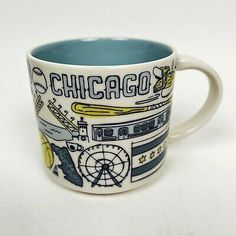 a chicago coffee mug with the word chicago on it and various things around it in blue