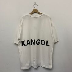 Kangol Tshirt Size : Large Measurement  Armpit : 25" Shoulder to bottom : 29" *Good used condition. *Small stain at front. *Overall condition is 8/10. #TSW-6 Oversized T-shirt With Letter Print And Drop Shoulder, White Slogan T-shirt Oversized, Oversized White Slogan T-shirt, Oversized White T-shirt With Letter Print, Cotton T-shirt With Letter Print And Drop Shoulder, Cotton Letter Print T-shirt With Drop Shoulder, Cotton Drop Shoulder T-shirt With Letter Print, Oversized Logo Print T-shirt With Drop Shoulder, Cotton T-shirt With Logo And Drop Shoulder