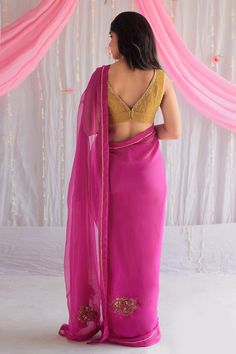 Fuchsia pink saree in chiffon base with hand embroidered floral motifs. Comes with unstitched blouse fabric.
Component: 2
Pattern: Embroidered
Type Of Work: Floral Motifs
Fabric: Chiffon
Color: Pink
Other Details: 
Floral buttas
Lace trim
Note: The blouse worn by the model is not for sale
Occasion: Wedding - Aza Fashions Saree For Women, Embroidered Saree, Pink Chiffon, Pantsuits For Women, Pink Saree, Floral Chiffon, Saree Styles, Blouse Fabric, Floral Motifs