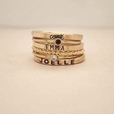 Our stacking rings are handmade in our Indiana studio. We use yellow gold solder on our rose gold filled rings because rose gold solder contains carcinogens. Please see the photo for more information about gold-filled jewelry, as it is an affordable alternative to solid gold. This listing includes 6 rings: - one 14K yellow gold filled 2 mm name ring in lowercase cursive - one 14K yellow gold filled 1 mm black cz ring - one 14K yellow gold filled 2 mm name ring in thin uppercase block - one 14K y Spacer Rings, Stackable Name Rings, Rings Stacking, Block Font, Ring Spacer, Wedding Ring Sizes, Name Ring, Name Rings, Stacking Ring Set