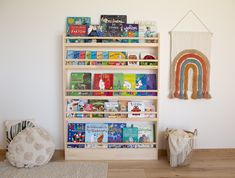 a bookshelf with several children's books on it next to a rug