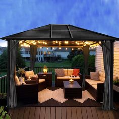 an outdoor living area with furniture and lights