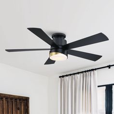 a black ceiling fan in a white room