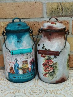 two ceramic jars sitting next to each other on a table