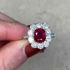 This ring features a cushion cut natural non-heated Burma ruby, weighing 1.46 carats and set in 18k yellow gold prongs. The center stone is certified by AGL. A halo of old mine cut diamonds surrounds the center stone. Old European cut diamonds are set along the shoulders, which are decorated with fine milgrain. The total diamond weight of this ring is 1.70 carats. This ring is carefully handcrafted with a platinum mounting.
The center stone is a 1.46 carat non-heated Burma ruby, certified by AGL Classic Gia Certified Cushion Cut Ruby Ring, Luxury Gia Certified Cushion Cut Ruby Ring, Classic Gia Certified Cushion-cut Ruby Ring, Red Diamond Ring With Brilliant Cushion Cut, Luxury Cushion Cut Ruby Ring With Diamond, Red Cushion Cut Brilliant Diamond Ring, Red Cushion Cut Diamond Ring With Brilliant Cut, Fine Jewelry Ruby Ring With Cushion Brilliant Cut, Luxury Red Cushion Cut Ruby Ring