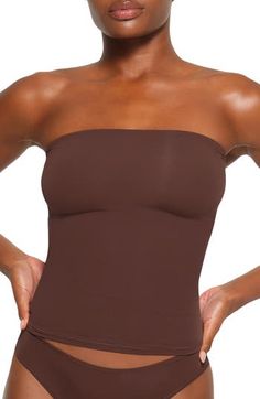 Sculpt your body's natural shape with a tube top from Kim Kardashian's SKIMS that holds you in and lifts you up in all the right places. Reflecting the brand's passion for highly technical shapewear solutions for every body, this tube top has whisper-soft seamless construction and is ideal as an underpinning or a solo piece. 15 1/2" length (size medium) 76% nylon, 24% spandex Machine wash, tumble dry Imported lined Fame Clothes, Slippers Outfit, Dr Closet, Classy Fits, Fits Clothes, Natural Shapes, Lookbook Outfits, Tube Top, Summer Girls