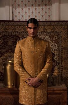 Classic Pakistani Men Sherwani and Trouser Groom Dress is a perfectly stitched masterpiece that gives the groom a magnificent look at the wedding. Premium fabric and embroidery make this beautiful Pakistani Groom Dress an epitome of beauty. Sherwani: Pakistani Groom Sherwani is embellished with graceful designs and embroidery work. Lavish details of tilla, sequins, and motifs enhance the royal look of this Sherwani Dress. Beaming fine details make this Sherwani your foremost priority for the big Formal Semi-stitched Naqshi Lehenga, Raw Silk Unstitched Suit With Dabka For Reception, Formal Naqshi Semi-stitched Lehenga, Traditional Sets With Gold Embroidery For Ceremony, Eid Reception Bandhgala With Intricate Embroidery, Reception Sets With Naqshi In Traditional Drape, Traditional Ceremony Sets With Gold Embroidery, Wedding Sets With Gold Embroidery For Transitional Season, Semi-stitched Naqshi Traditional Wear For Reception