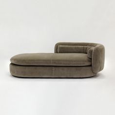 a grey couch sitting on top of a white floor