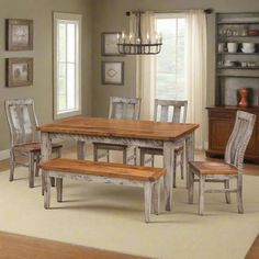 a dining room table with chairs and benches