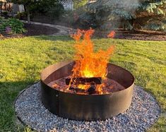 a fire pit sitting in the middle of a yard