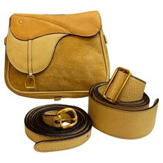 This vintage GUCCI mini saddle bag is crafted of pigskin and nubuck leather in two shades of yellow featuring gold toned hardware. This bag features a detachable crossbody strap and a belt of the same leather for wearing it as a crossbody or belt bag. Front magnetic snap closure decorated with a stirrup charm opens to a diamanté jacquard interior. Made in Italy. Measures approximately 6.5 x 6 x 1.5 inches Strap drop 22-25 inches Belt length 39 inches. Comes with dust bag/crossbody strap/belt. Condition - Good vintage condition with minor signs of wear Outside: Minor marks and rubbing on nubuck leather Inside: Minimal to no visible signs of wear Smell: No odor Luxury Vintage Saddle Bag With Leather Lining, Mini Saddle Bag, Crossbody Belt Bag, Gucci Mini, Gucci Crossbody Bag, Gucci Crossbody, Gucci Outfits, Gucci Tote, Belt Length