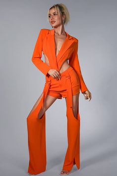 a woman in an orange outfit posing for the camera