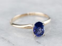 This is a classic engagement ring with clean lines and great proportions! This ring is quite traditional, featuring a solid gold head to hold the stone securely. Polished yellow gold shoulders complete the simple look. We've set this versatile piece with an intense sapphire, an exquisite cornflower blue that is bright and shining. The value of this gem is found in its quality - this is a benchmark gem, of the ultimate color and clarity that other sapphires can be compared against. Metal: 14K Yel Classic Oval Sapphire Ring, Classic Sapphire Ring Gift, Classic Solitaire Sapphire Ring, Classic Oval Sapphire Ring With Tension Setting, Classic 14k Gold Sapphire Ring With Tension Setting, Classic Sapphire Ring With Tension Setting For Promise, Timeless 14k Gold Solitaire Sapphire Ring, Classic Solitaire Sapphire Ring For Anniversary, Classic 14k Gold Sapphire Promise Ring