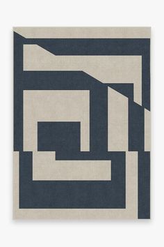 a blue and white rug with an abstract design on the bottom corner, in shades of grey