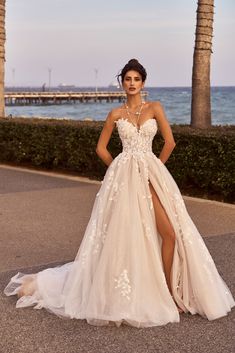 a woman in a wedding dress posing for the camera