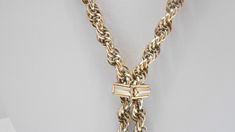 "Vintage gold tone 28\" lariat chain necklace. Intertwined chain links. Pullover necklace...no fastener. Four gold tone dangles. Necklace is adjustable with a square gold tone metal attachment. Classic necklace. Excellent condition. Unsigned." Formal Lariat Toggle Necklace With Chain, Formal Lariat Toggle Necklace, Metal Lariat Necklace With Chain, Metal Lariat Necklace With Chain Detail, Metal Lariat Necklace, Formal Lariat Toggle Necklace With Adjustable Chain, Formal Gold-tone Metal Toggle Necklace, Gold Metal Lariat Necklace With Lobster Clasp, Formal Gold-tone Toggle Necklace