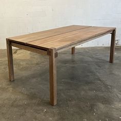 a wooden table sitting on top of a cement floor