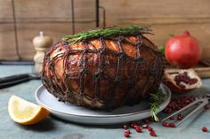 a meatloaf on a plate with garnishes and cranberries