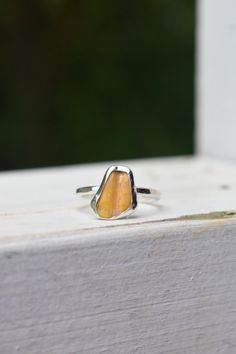 A beautiful sunrise shell chip found on the west side beach of Kauai made into a simple dainty sterling silver ring. The sunrise shell is a shell only to be found on the islands of Hawaii and mimicks the stunning colors of our sunsets. Islands Of Hawaii, Sunrise Shell, Hawaii Island, Beautiful Sunrise, The Sunrise, West Side, Kauai, Rings Statement, Sterling Silber