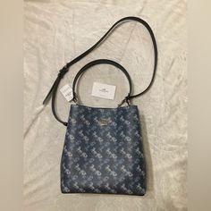 Authentic Blue Printed Coated Canvas And Smooth Leather Bucket Bag. It Has A Center Zip Compartment, Snap Closure, And Silver Hardware. Approximate Measurements Are: 10 1/4" (L) X 10" (H) X 5" (W) Handle With 8" Drop Detachable Strap With 20 1/2" Drop For Shoulder Or Crossbody Wear. No Trades Or Low Ball Offers. Luxury Blue Bucket Bag With Double Handle, Designer Blue Rectangular Bucket Bag, Designer Blue Bucket Bag With Dust Bag, Designer Blue Bucket Bag For Travel, Designer Blue Bucket Bag, Blue Top Handle Bucket Bag For Shopping, Blue Formal Bucket Bag, Formal Blue Bucket Bag, Blue Satchel Bucket Bag With Dust Bag