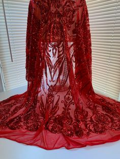 a red dress on display in front of a window