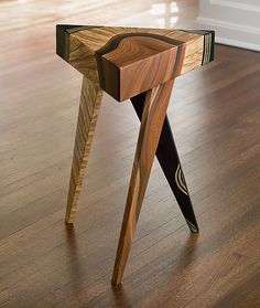 a wooden table that is on top of a hard wood floor