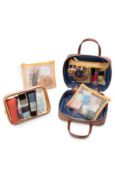 This easy-to-organize travel-friendly makeup kit has two snap-out mesh pouches, a removable toiletry pouch and a clear zip pocket. Zip-around closure   Top carry handles   Interior zip pocket; two removable zip-closure mesh pouches; removable zip-closure toiletry pouch; removable mirror   50% recycled polyurethane/polyurethane   Imported Stephanie Johnson, Toiletry Pouch, Makeup Kit, Cosmetic Case, Cognac, Camera Bag, Zip Pockets, Handles, Pouch