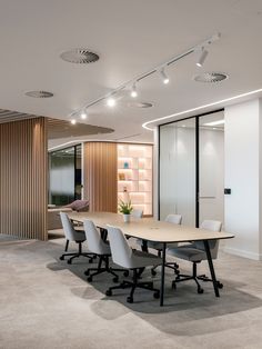 an empty conference room with white chairs and wood paneling