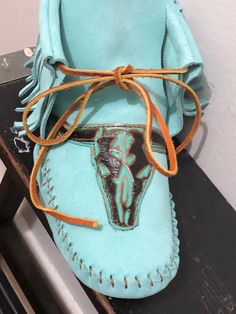 These handmade moccasins will not disappoint.  Crafted of a vibrant aqua suede and adorned with the longhorn. Completely made of leather. Western Leather Moccasins For Festival, Western Style Slip-on Moccasins For Festivals, Western Style Leather Moccasins For Festivals, Artisan Handmade Leather Moccasins, Leather Moccasins Diy, Native American Boots, Moccasin Patterns, Diy Moccasins, Native American Moccasins