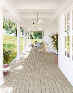 an empty porch with chairs and potted plants