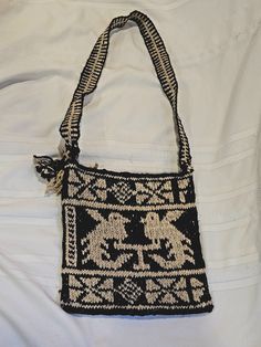 Add a touch of bohemian art to your casual outfit with this vintage handmade wool crossbody bag. The dark brown exterior is handwoven with a beautiful pattern, while the brown wool strap adds a cozy touch. The medium-sized bag is lined with wool and features a cross-body strap for comfortable wear. This Guatemalan Morral purse is perfect for a day out or a casual night with friends. The bag is pre-owned, but in excellent condition, adding to its vintage charm. The bag also comes with an extra st Medium Sized Bags, Bohemian Art, Hobo Handbags, Vintage Charms, Beautiful Patterns, Casual Outfit, Purses And Handbags, Hand Woven, Cross Body