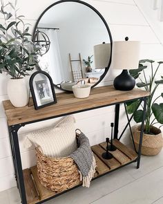 a mirror and some plants on a table