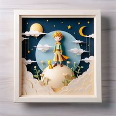 a paper sculpture of a boy standing on top of a cloud covered hill with stars and moon