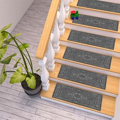 a potted plant sitting on top of a wooden stair case next to a set of carpeted stairs