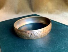 "Vintage Brass Hand Engraved Wide Bangle Bracelet. This floral design bracelet is in very good vintage condition except some minor tarnish stains. Please see the attached photos for details. Dimensions: 2.65\"Diameter x 0.50\" W Thank you for checking out our shop! Kindly keep in mind that all of the items we sell are vintage or antique, and as such may have signs of wear in keeping with age and use. We will try our best to indicate any damage and to show the detail in the attached photographs." Brass Hand, Design Bracelet, Brass Candle Holders, Brass Candle, Vintage Art Prints, Candle Set, 1950s Vintage, Hand Engraving, Tea Bag