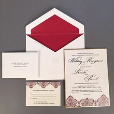 a red and white wedding suite with matching envelope