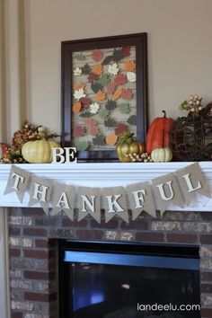 a mantel decorated with pumpkins, leaves and bunting banner for a thanksgiving mantle