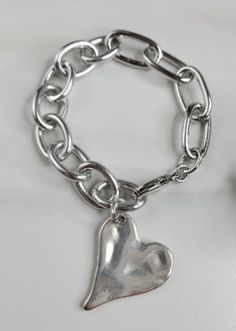 Suki Bracelet Handmade with Chain and Heart Charm Trendy Silver Heart Bracelet For Friendship, Trendy Silver Heart Bracelet For Gift, Silver Heart Charm Bracelet For Friendship, Trendy Metal Heart Bracelet As A Gift, Trendy Metal Bracelets With Heart Charm, Heart-shaped Metal Charm Bracelet For Friendship, Trendy Heart-shaped Chain Bracelets, Trendy Heart-shaped Chain Bracelet, Trendy Personalized Silver Heart Bracelet