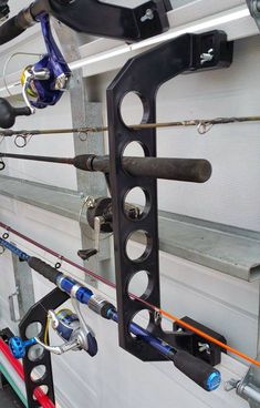 several fishing rods are attached to the side of a boat's door with hooks