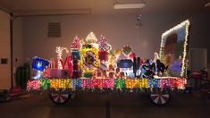 an elaborately decorated train with lights and decorations