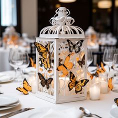 a white lantern with yellow butterflies on it sitting on top of a dining room table