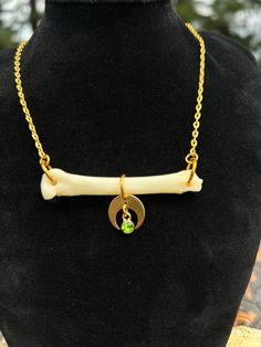 Necklace featuring genuine coyote foot bone with crescent moon & faux peridot gemstone. Comes on gold tone steel chain with a lobster claw clasp. Necklace is approximately 17.5 inches long. Cruelty free - Ethically sourced As the materials used come from nature they can be delicate. They may break if bent or smashed. It is advised that you not submerge them in water for long periods of time (wearing while swimming, showering, etc) as this may cause the materials to weaken or break down. Moon Gold Necklace, Moon Gold, Bone Necklace, Clasp Necklace, Jewelry Techniques, Peridot Gemstone, Wedding Jewellery Necklace, Jewelry Inspo, Steel Chain