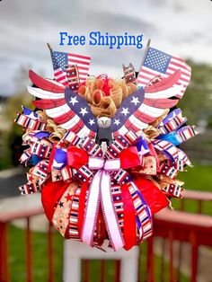 a patriotic wreath with the words free shipping on it and an american flag bow attached to it