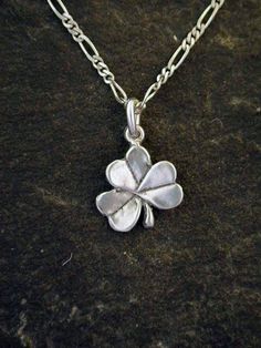 This Clover pendant is Sterling Silver. The included chain is a Sterling Silver Figaro 50 chain. You may chose 16, 18, or 20" chain extra charge. The Clover pendant measures 5/8" tall by 9/16" across. I hand cast all my pieces using the lost wax casting method. Please ask your needs. You may call me with questions, often I am out so please use my machine. Call Pete Conder 831-476-3176. Satisfaction Guaranteed!I send items USPS First Class unless otherwise directed. I send as soon as I can, usual Silver Charm Necklaces With Adjustable Chain For Good Luck, Silver Flower Pendant Chain Necklace As Gift, Silver Chain Necklace With Flower Pendant For Gift, Celtic Knot Earrings, Clover Pendant, Seahorse Pendant, Tahitian Black Pearls, Wax Casting, Knot Earrings