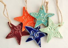 four ceramic starfish ornaments hanging from twine