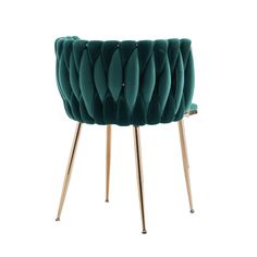 a green velvet chair with gold legs