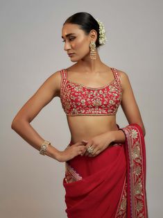 Editor's Note A classic red sari featuring delicate gold embroidery, paired with a stunning sleeveless hand-embroidered blouse. The sari is a statement of regal and royal elegance. Red Blouse Design, Sleeveless Blouse Designs, Popup Shop, Red Sari, Fancy Blouses, Fancy Blouse Designs, Embroidery Blouse Designs, Gold Embroidery, Embroidery Blouse