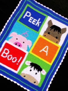 a cross stitched patch with animals and letters on it that says peek a boo